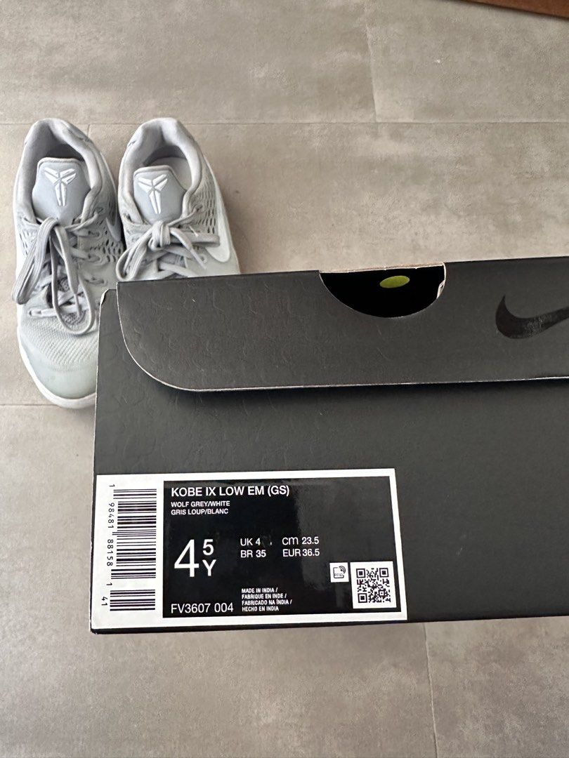 Nike Kobe IX Low EM (GS) Grey/White (Category: Sneakers) located in Naga. Submitted by jenni2003 (Listing ID 1435000935, Image 2). Description: Nike Kobe IX Low EM (GS) in grey and white. The shoes come with the original box. Size is 4.5Y, UK 4, CM 23.5, and BR 35. The box has the Kobe logo and signature. The shoes have grey laces and a grey upper. The soles are white..