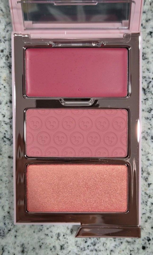 One/Size Cheek Clapper 3D Blush Trio in Phat A$$ (Category: Makeup) located in Taguig. Submitted by kahlilsantiago (Listing ID 1435146940, Image 3). Description: - Cheek Clapper 3D Blush Trio - Includes cream and powder blushes - Shades: Twerkalicious, Rosebud, and Eel - Features a mirror and a sleek pink case - Cream blush: 4.0g - Powder blush: 2 x 3.5g - Product details printed on the back.