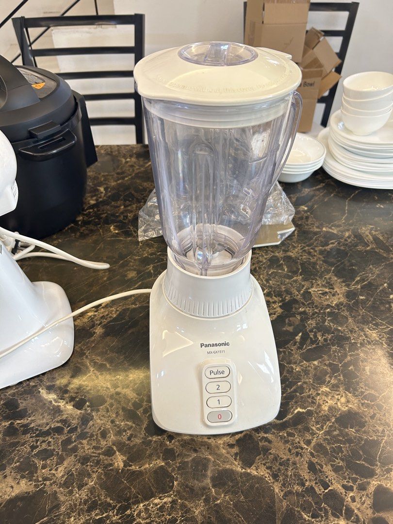 Panasonic MX-GX1511 Blender (Category: Juicers, Blenders & Grinders) located in Makati City. Submitted by declutter__queen (Listing ID 1435046278, Image 2). Description: - Panasonic MX-GX1511 Blender - Multiple speed settings: 0, 1, 2, and Pulse - Clear plastic jug - White base - Includes lid and power cord - Features a warning label on the base.