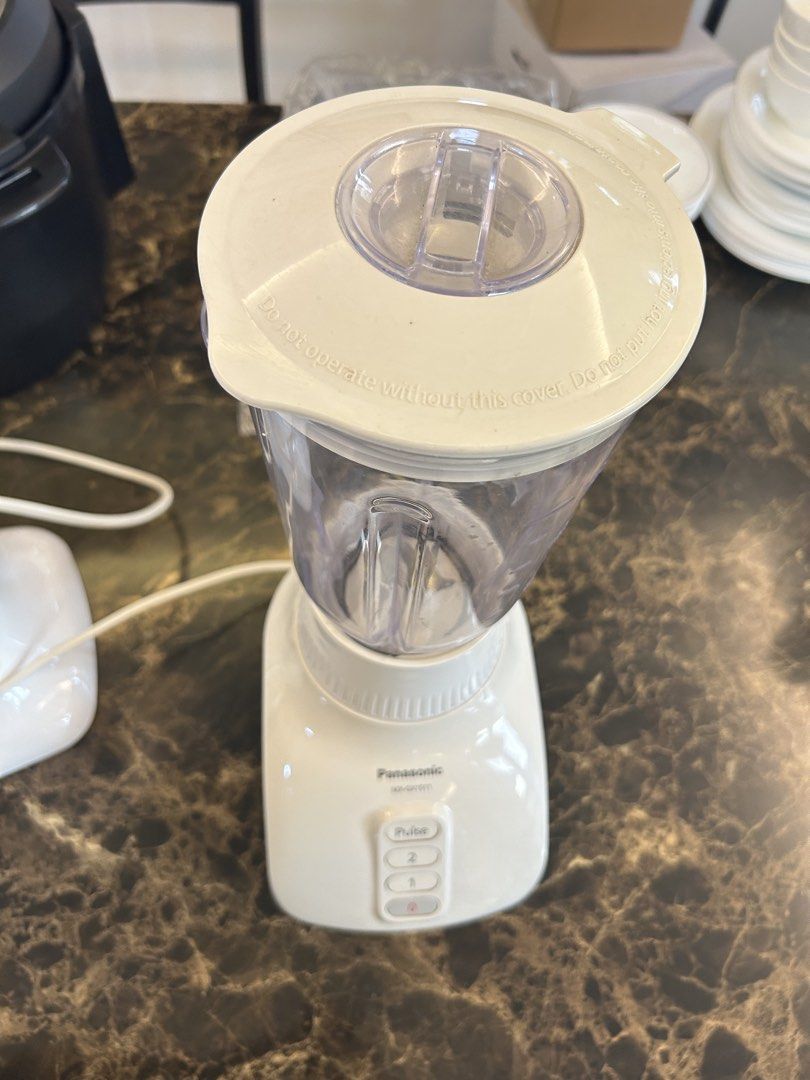 Panasonic MX-GX1511 Blender (Category: Juicers, Blenders & Grinders) located in Makati City. Submitted by declutter__queen (Listing ID 1435046278, Image 3). Description: - Panasonic MX-GX1511 Blender - Multiple speed settings: 0, 1, 2, and Pulse - Clear plastic jug - White base - Includes lid and power cord - Features a warning label on the base.
