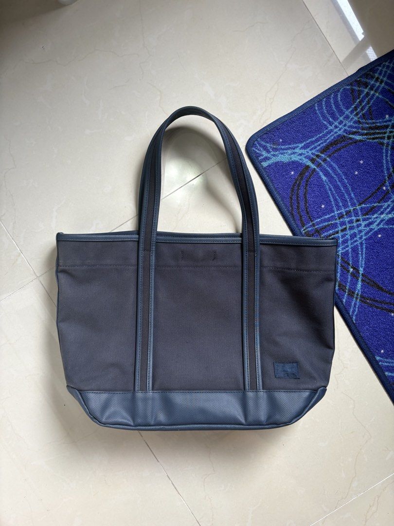 Porter Girl Tote bag (Category: Luxury Bags & Wallets) located in General Trias. Submitted by snkrshzw (Listing ID 1435081375, Image 1). Description: Porter Girl Tote Bag Color: Dark Navy Blue Outer material: Cotton canvas Inner material: PVC 1 exterior pockets, 5 mesh pockets, 1 main compartment Can fit 15” laptop Medium sized tote Approximately L15 W5.5 (expandable) H11.5 in.