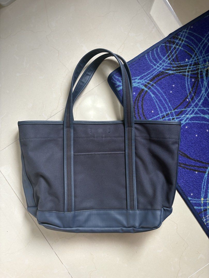 Porter Girl Tote bag (Category: Luxury Bags & Wallets) located in General Trias. Submitted by snkrshzw (Listing ID 1435081375, Image 2). Description: Porter Girl Tote Bag Color: Dark Navy Blue Outer material: Cotton canvas Inner material: PVC 1 exterior pockets, 5 mesh pockets, 1 main compartment Can fit 15” laptop Medium sized tote Approximately L15 W5.5 (expandable) H11.5 in.