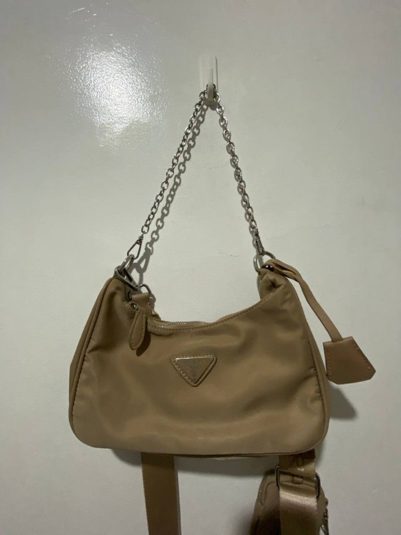 Prada Re-Edition 2005 Shoulder Bag (Category: Luxury Bags & Wallets) located in Manila. Submitted by otwentyseven (Listing ID 1435113328, Image 2). Description: - Prada Re-Edition 2005 shoulder bag - Beige nylon exterior - Detachable pouch included - Chain strap and adjustable shoulder strap - Silver-tone Prada logo - Secure zipper closure - Neutral color for versatile styling.