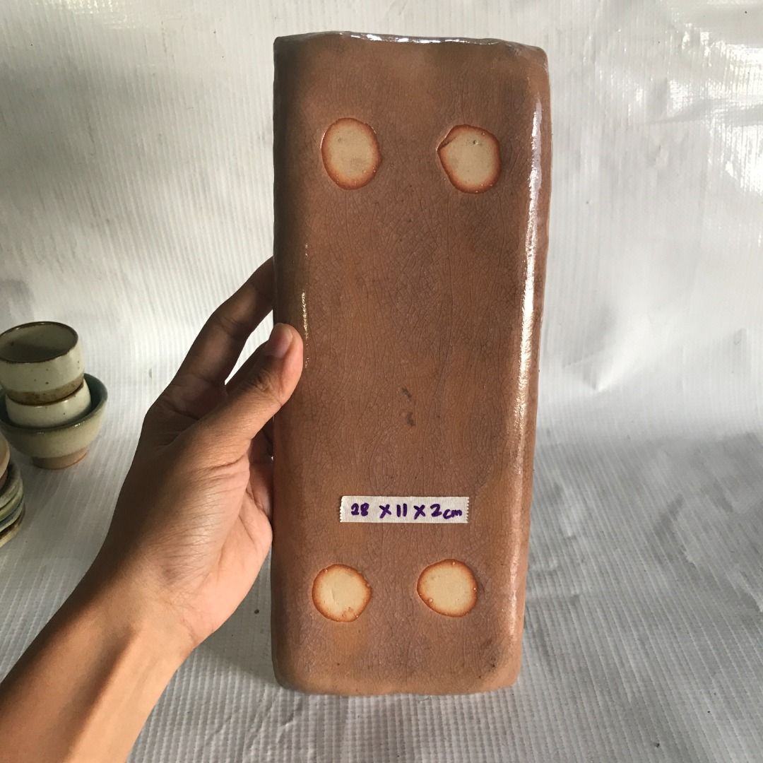 Rectangular Ceramic Serving Tray #4561 (Category: Other Kitchenware & Tableware) located in Malabon City. Submitted by mldg.surplus (Listing ID 1435083749, Image 2). Description: - Ceramic serving tray - Brown color - Dimensions: 28 x 11 x 2 cm - Suitable for serving food or decoration - Unique shape with curved edges MLDG Surplus Reminder: •Expect minimal flaws such as stain, lint, scratches etc. •No reservation, we can accept your offer, but it