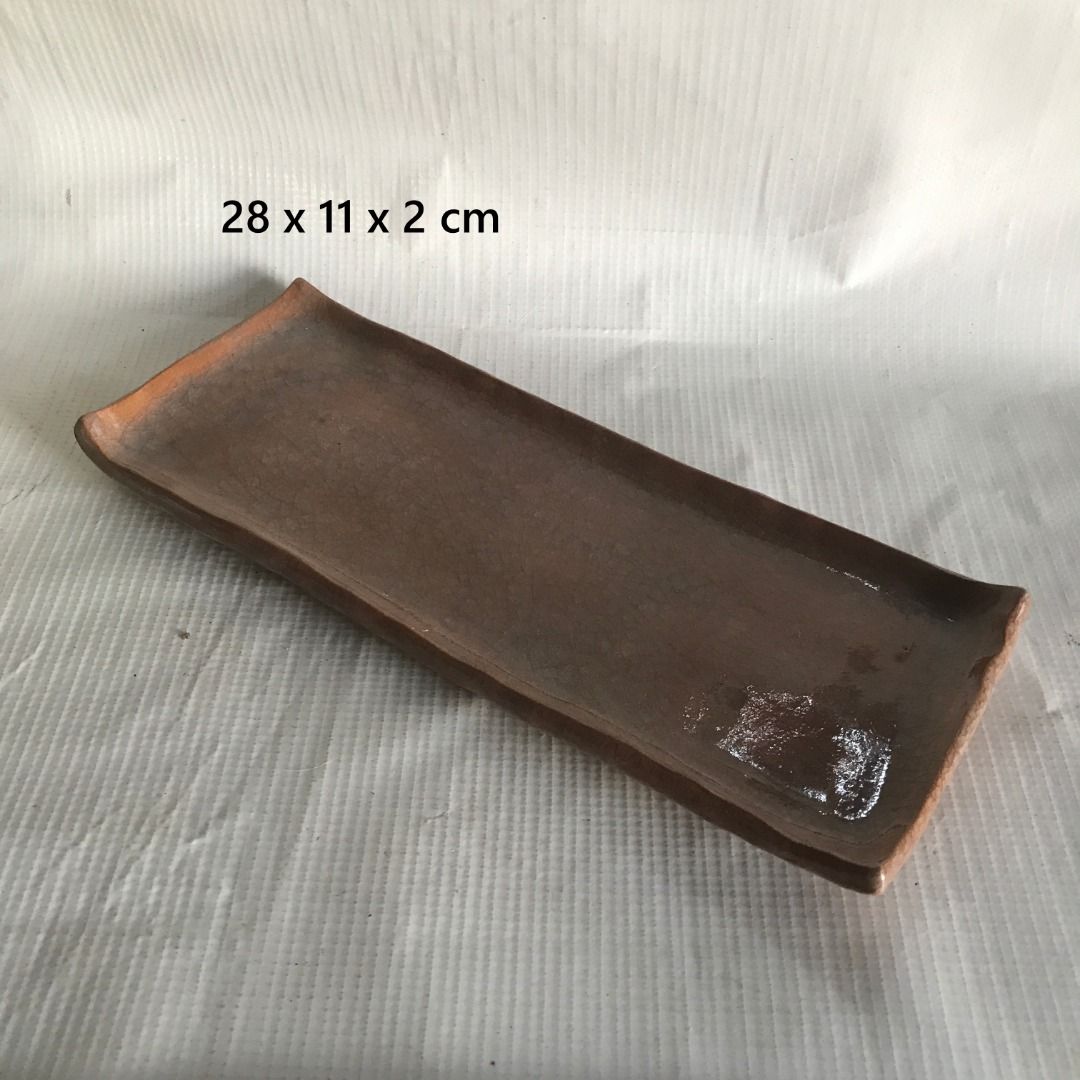 Rectangular Ceramic Serving Tray #4561 (Category: Other Kitchenware & Tableware) located in Malabon City. Submitted by mldg.surplus (Listing ID 1435083749, Image 1). Description: - Ceramic serving tray - Brown color - Dimensions: 28 x 11 x 2 cm - Suitable for serving food or decoration - Unique shape with curved edges MLDG Surplus Reminder: •Expect minimal flaws such as stain, lint, scratches etc. •No reservation, we can accept your offer, but it