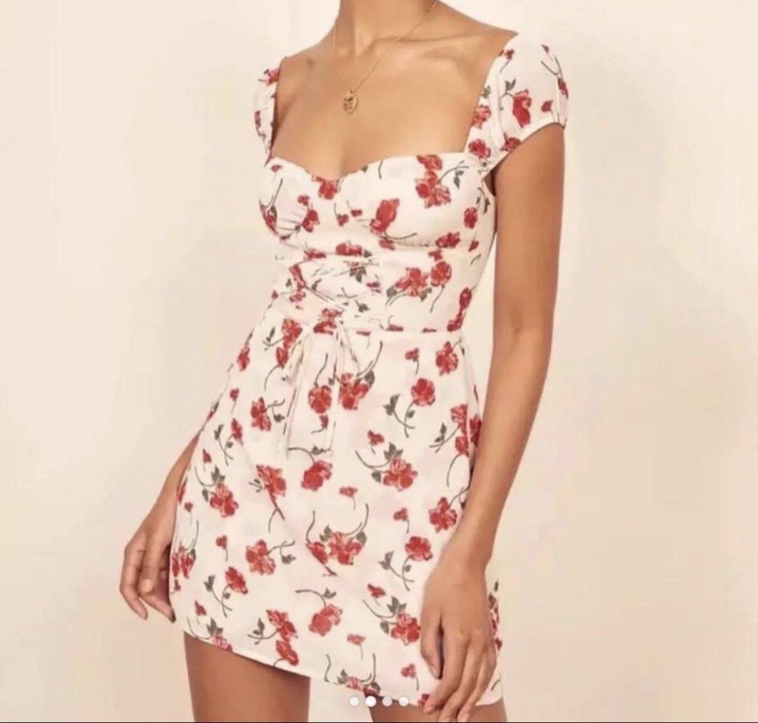 Reformation floral mini dress (AUTHENTIC) (Category: Dresses) located in Manila. Submitted by plsbuymyoldthingsheheh (Listing ID 1435169283, Image 1). Description: - MONEY BACK IF PROVEN FAKE. AUTHENTIC REFORMATION - Floral print mini dress - Red flowers on a cream background - Sweetheart neckline - Cap sleeves - Lace-up front detail - Lightweight fabric - Fitted bodice - Slightly flared skirt - Ideal for warm weather.