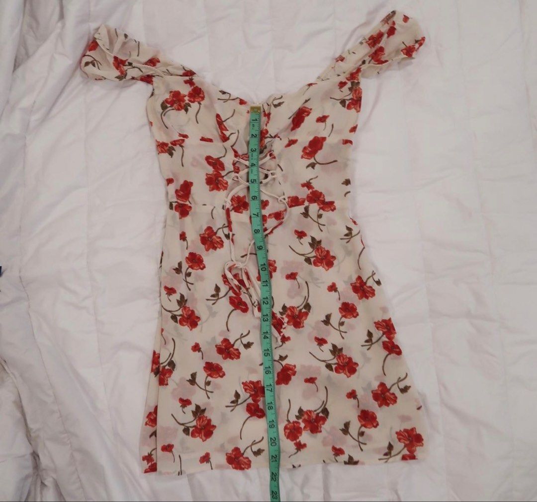 Reformation floral mini dress (AUTHENTIC) (Category: Dresses) located in Manila. Submitted by plsbuymyoldthingsheheh (Listing ID 1435169283, Image 2). Description: - MONEY BACK IF PROVEN FAKE. AUTHENTIC REFORMATION - Floral print mini dress - Red flowers on a cream background - Sweetheart neckline - Cap sleeves - Lace-up front detail - Lightweight fabric - Fitted bodice - Slightly flared skirt - Ideal for warm weather.