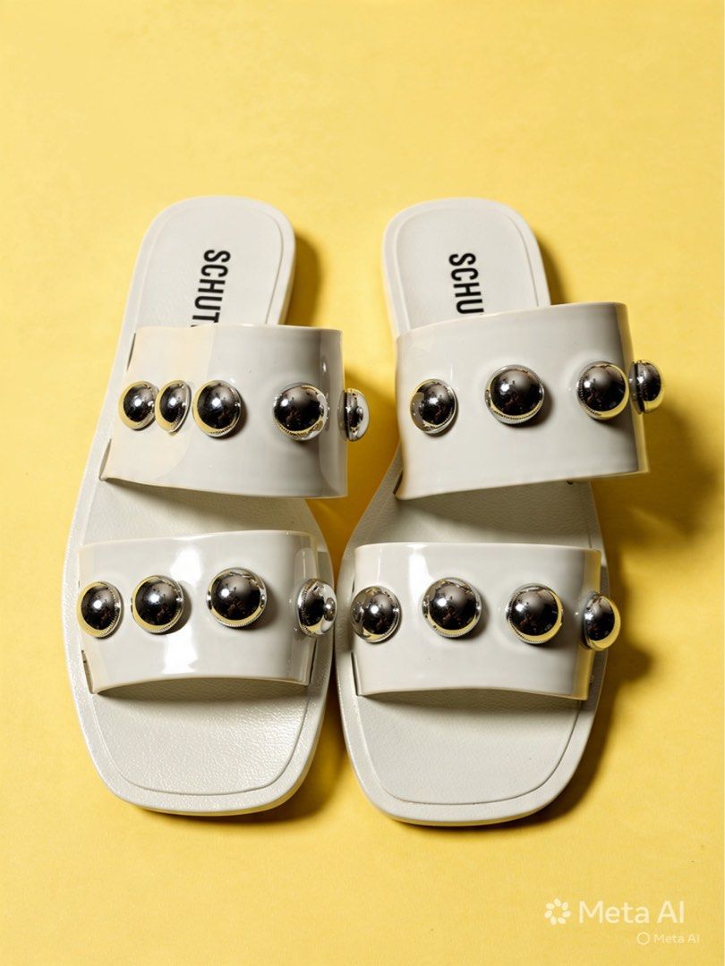 Schutz Studded White Sandals (Category: Flats & Sandals) located in Antipolo. Submitted by cl026 (Listing ID 1435016618, Image 1). Description: - Schutz sandals in white - Double-strap design - Silver-colored studs - Light beige soles - Made in Brazil - Size 36 EUR / 6 USA.