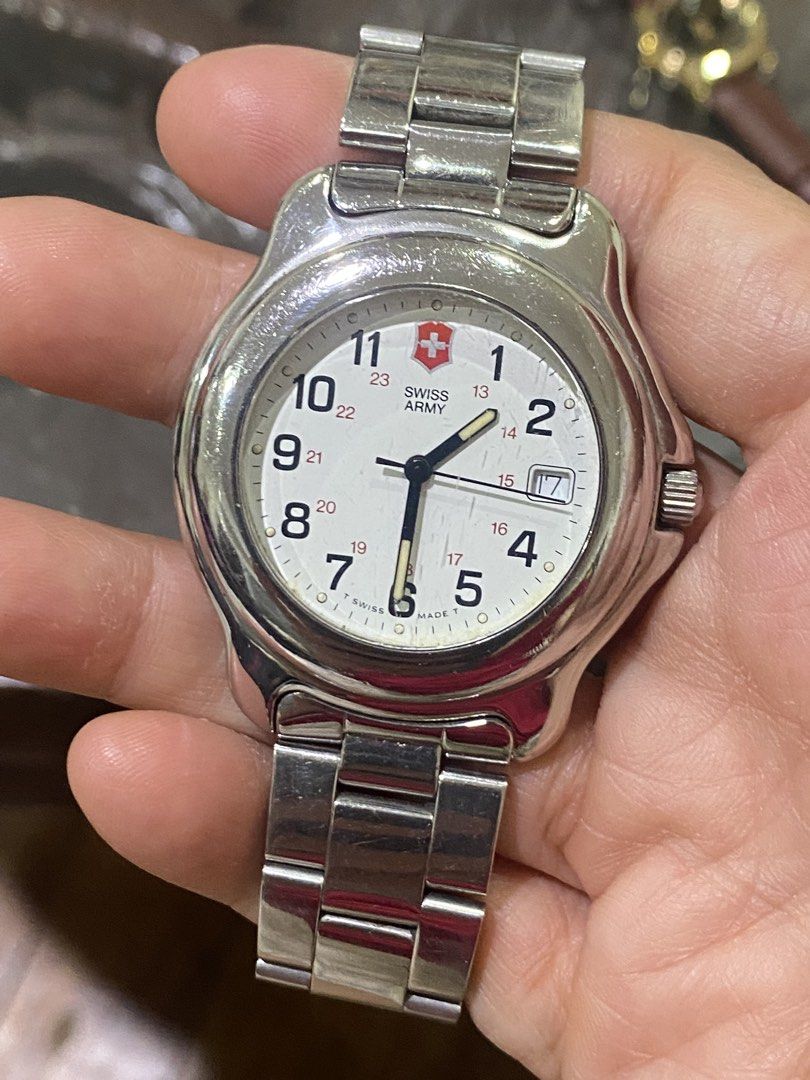 Swiss Army Watch (Category: Men's Watches) located in Manila. Submitted by roseluxuryitems (Listing ID 1435157376, Image 3). Description: - Swiss Army watch - White dial - Silver-tone stainless steel bracelet - Date display at 3 o'clock - Silver case - Arabic numerals and military time scale.