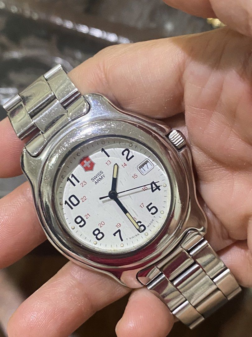 Swiss Army Watch (Category: Men's Watches) located in Manila. Submitted by roseluxuryitems (Listing ID 1435157376, Image 1). Description: - Swiss Army watch - White dial - Silver-tone stainless steel bracelet - Date display at 3 o'clock - Silver case - Arabic numerals and military time scale.