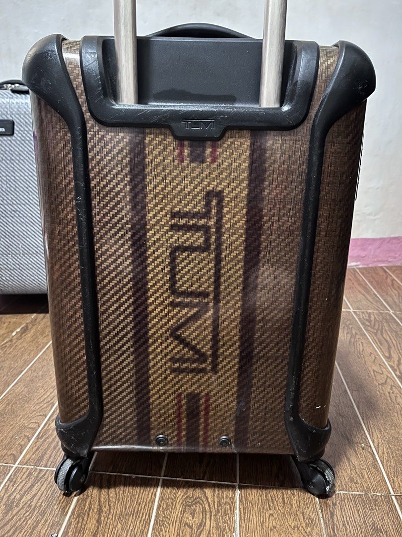 Tumi Carry-on Luggage (Category: Luggage) located in Victorias. Submitted by lan1877 (Listing ID 1435016979, Image 2). Description: - Tumi carry-on luggage - Unique woven pattern - TSA lock for security - Retractable handle and wheels for easy transport - Black interior lining with Tumi tag - Tumi logo on front and back.