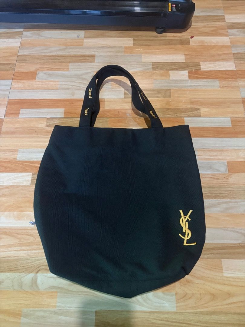 YSL Black Tote Bag (Category: Luxury Bags & Wallets) located in Tubigon. Submitted by wawiesunbe75372 (Listing ID 1435057103, Image 1). Description: - Black tote bag - Gold YSL logo - Pink interior lining - Small interior pocket with YSL logo - YSL branded handles - Perfect for everyday use.