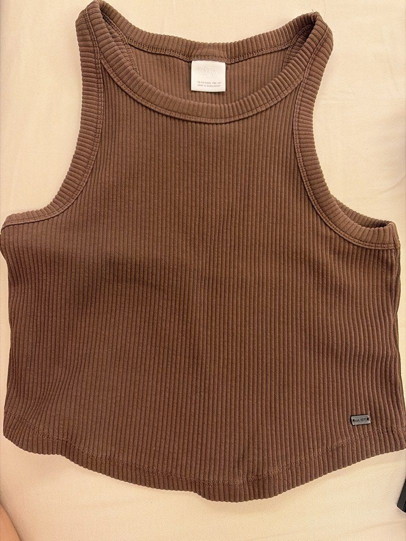 Zara Ribbed Tank Top (Category: Sleeveless) located in Paranaque City. Submitted by triciadeclutter (Listing ID 1435145664, Image 1). Description: - Zara brown ribbed tank top - Size: 13-14 years fits adult XS to semi M (stretchy) - Versatile piece for layering or wearing alone.