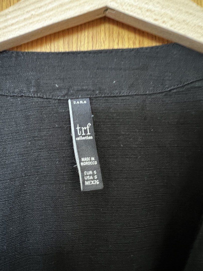 Zara TRF Black Dress (Category: Dresses) located in Manila. Submitted by thejenclai01765 (Listing ID 1435153506, Image 2). Description: - Zara TRF black dress - Size: S - Features: Button-down front, tie-waist, short sleeves - Made in Morocco.