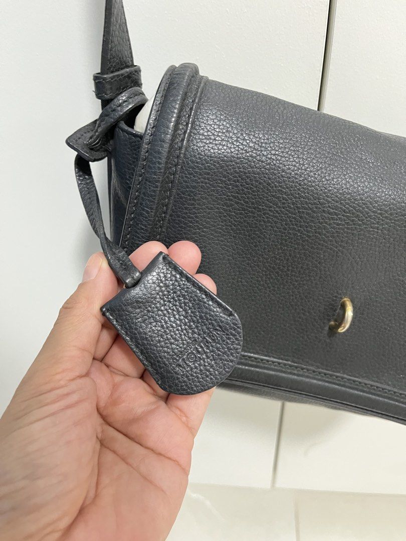 Alexander McQueen Black Leather Crossbody Bag (Category: Luxury Bags & Wallets) located in Makati City. Submitted by anndeetree (Listing ID 1429946720, Image 3). Description: Black leather crossbody bag by Alexander McQueen. Features a flap closure with a metal detail. The interior includes a zippered pocket and a small pouch with the brand's logo. The bag has a long, adjustable strap. The interior also has a small tag with the brand's name..