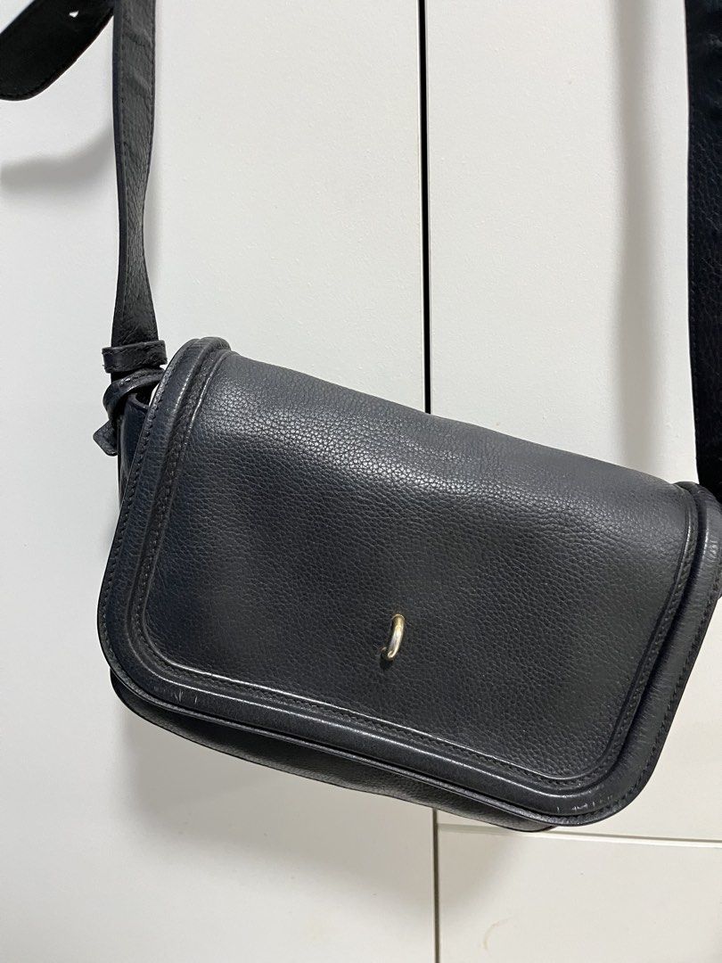 Alexander McQueen Black Leather Crossbody Bag (Category: Luxury Bags & Wallets) located in Makati City. Submitted by anndeetree (Listing ID 1429946720, Image 2). Description: Black leather crossbody bag by Alexander McQueen. Features a flap closure with a metal detail. The interior includes a zippered pocket and a small pouch with the brand's logo. The bag has a long, adjustable strap. The interior also has a small tag with the brand's name..