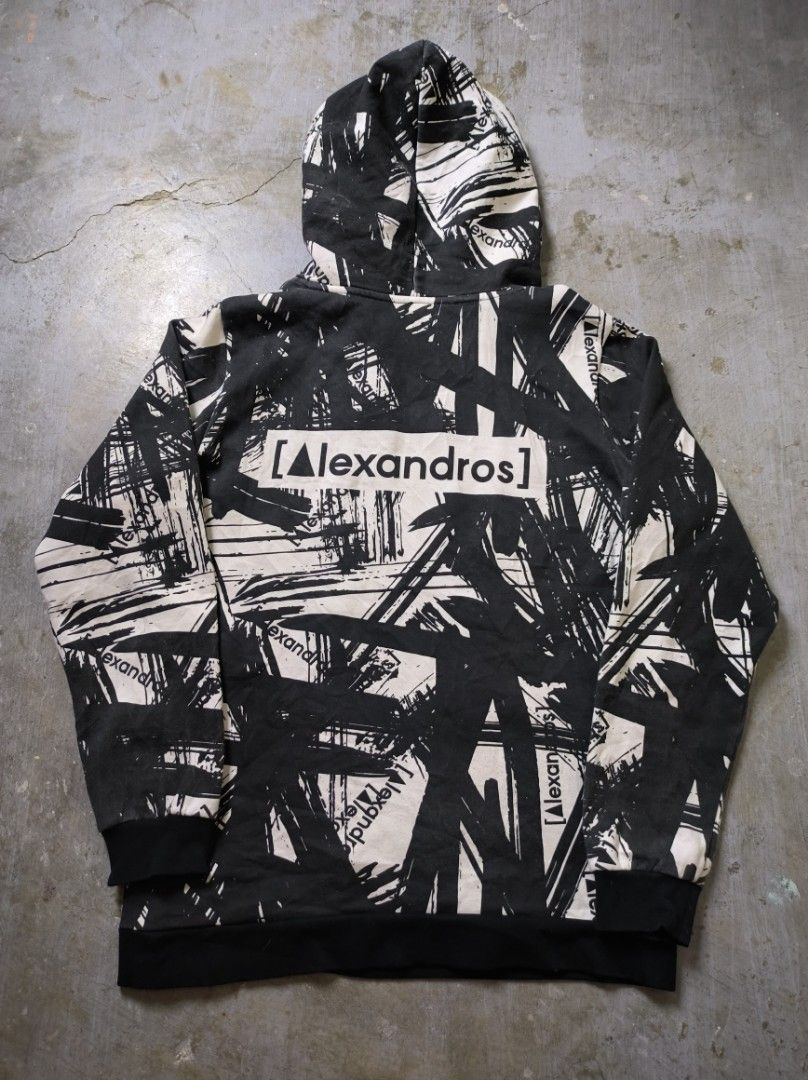 Alexandros Hoodie AOP (Category: Hoodies) located in Manila. Submitted by suppliermo (Listing ID 1429909041, Image 3). Description: Alexandros hoodie with a unique black and white brushstroke design. Features a hood and a front pocket. The brand name is prominently displayed on the front and back. The cuffs and hem are black. The hoodie has a tag with the brand name on the bottom right..
