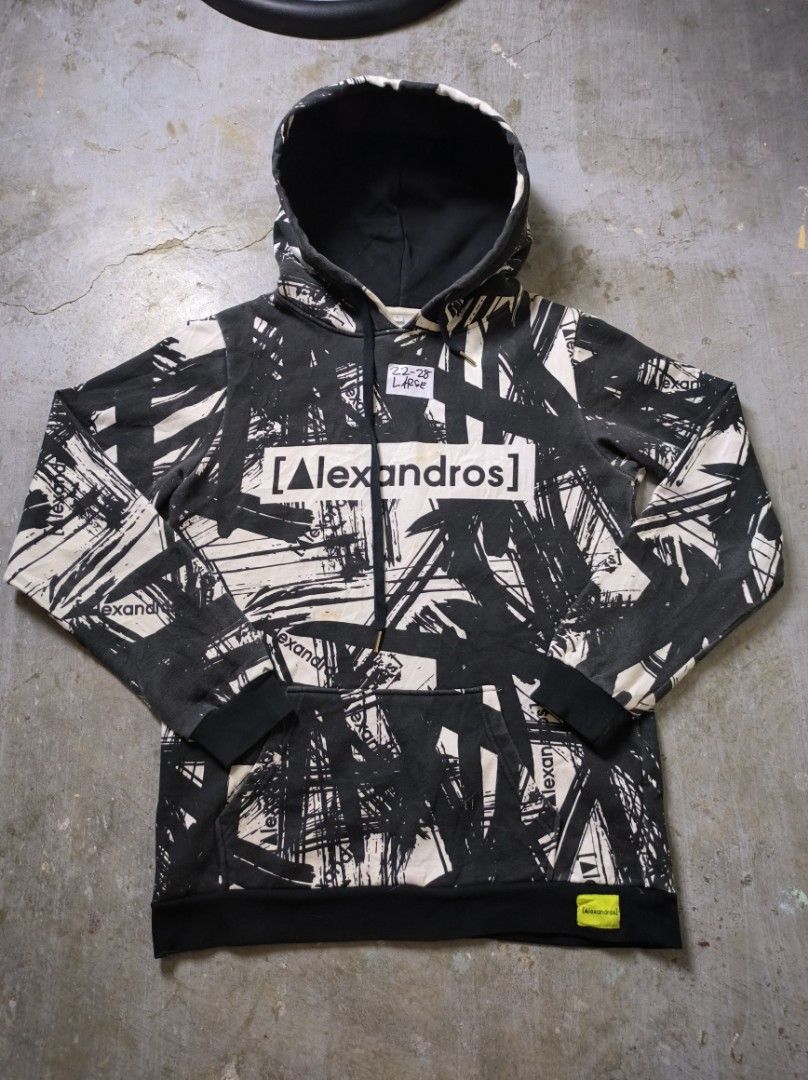 Alexandros Hoodie AOP (Category: Hoodies) located in Manila. Submitted by suppliermo (Listing ID 1429909041, Image 1). Description: Alexandros hoodie with a unique black and white brushstroke design. Features a hood and a front pocket. The brand name is prominently displayed on the front and back. The cuffs and hem are black. The hoodie has a tag with the brand name on the bottom right..