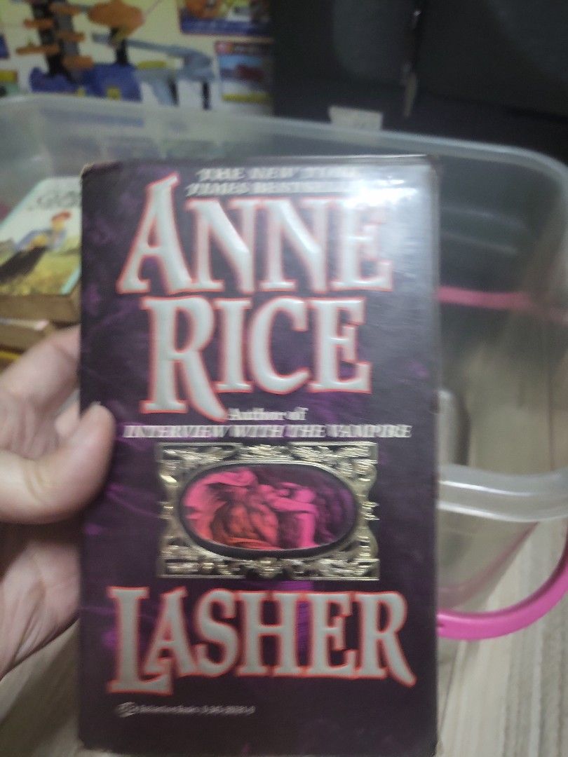 Anne Rice Lasher Book (Category: Storybooks) located in Caloocan City. Submitted by lynette1977 (Listing ID 1429964912, Image 1). Description: Copy of Anne Rice's novel, Lasher. The book has a purple cover with the title and author's name clearly visible. The back of the book contains text and a barcode..