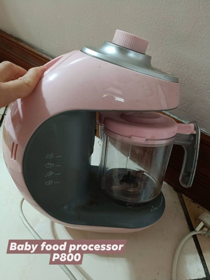 Baby Food Processor (Category: Weaning & Toddler Feeding) located in Makati City. Submitted by jstreasuredfinds (Listing ID 1429976371, Image 1). Description: Pink baby food processor. It has a clear container with a handle and a pink lid. The base has several buttons. The price is P800..