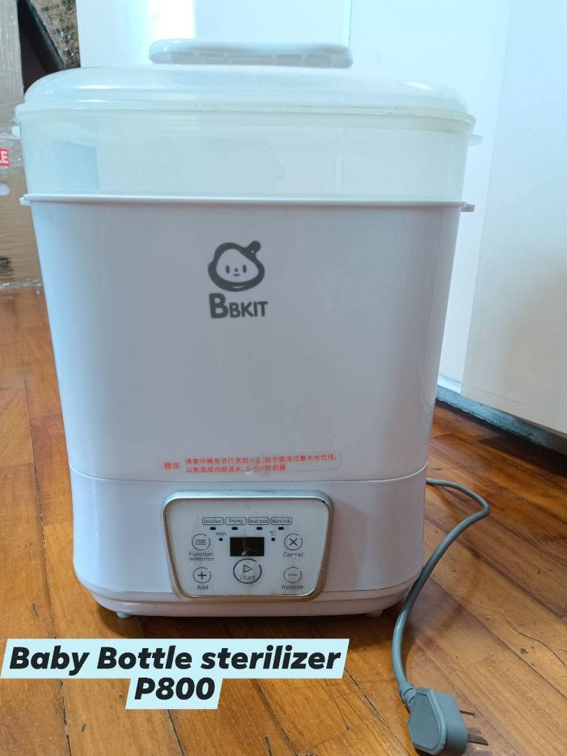 BbkIT Baby Bottle Sterilizer (Category: Breastfeeding & Bottle Feeding) located in Makati City. Submitted by jstreasuredfinds (Listing ID 1429957826, Image 1). Description: BbkIT baby bottle sterilizer. Features a digital display and control panel. Includes a clear top and a white body. The power cord is included. Price is P800..