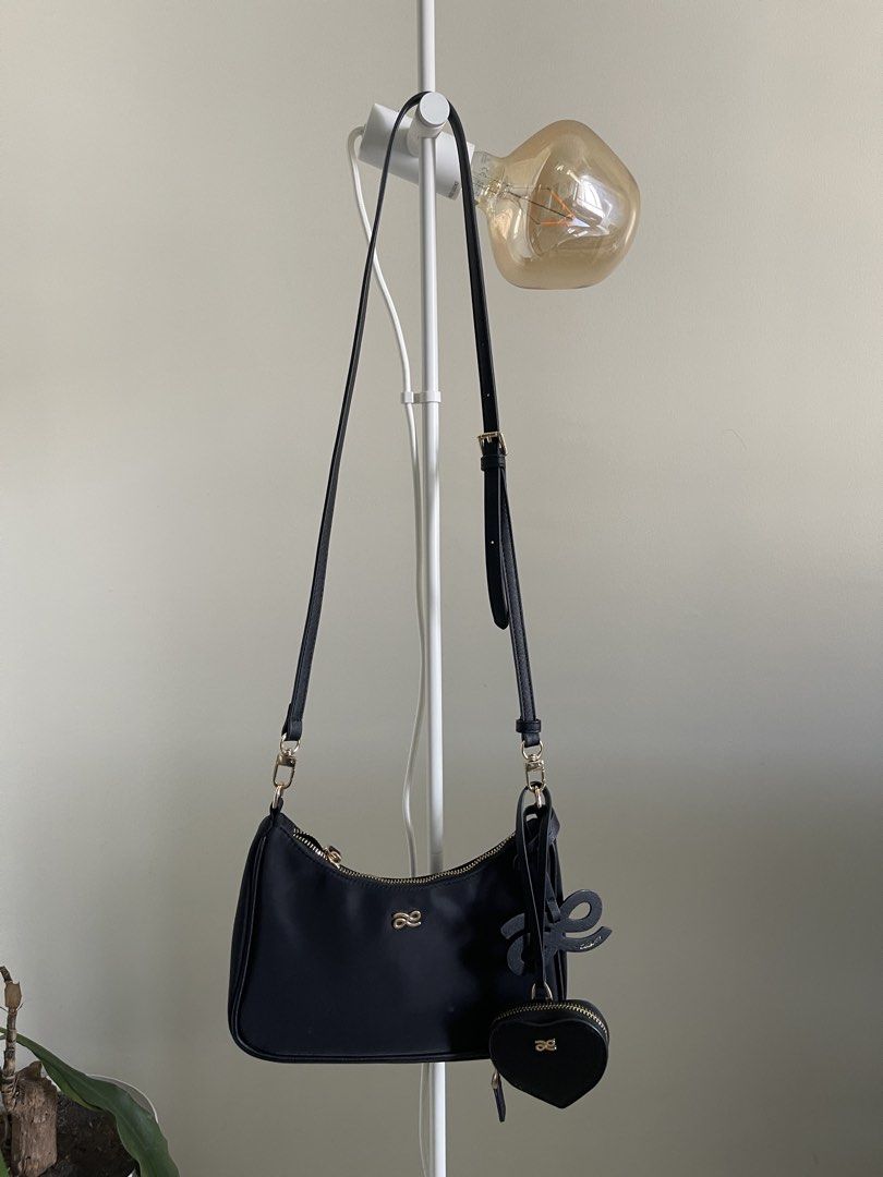 Black Shoulder Bag with Heart Charm (Category: Shoulder Bags) located in Manila. Submitted by declutterwnikki (Listing ID 1429981208, Image 2). Description: 🖤 Little Bunny Black Shoulder Bag w/ Heart Pouch 🖤 Selling this super cute Little Bunny shoulder bag ✨ ✔️ Comes with heart-shaped coin pouch (removable 💖) ✔️ Sleek black design – matches everything ✔️ Gold hardware for a classy touch ✔️ Can be worn shoulder or crossbody ✔️ Perfect for dail