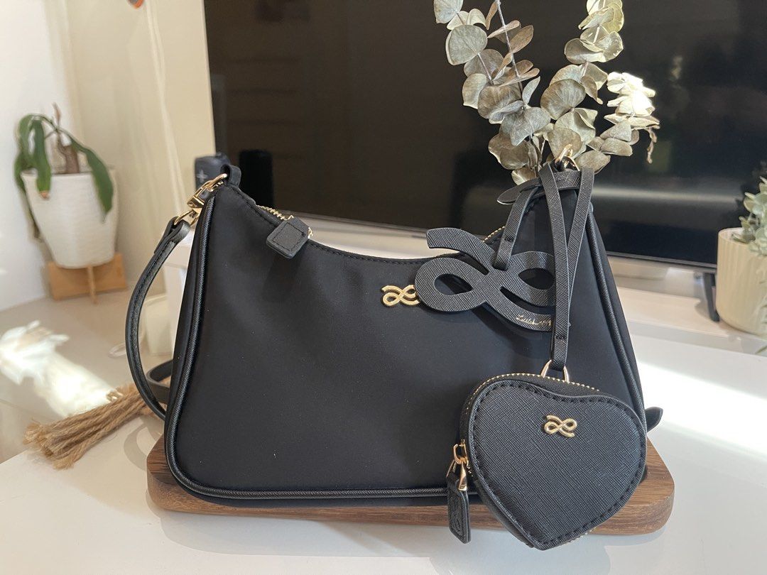 Black Shoulder Bag with Heart Charm (Category: Shoulder Bags) located in Manila. Submitted by declutterwnikki (Listing ID 1429981208, Image 1). Description: 🖤 Little Bunny Black Shoulder Bag w/ Heart Pouch 🖤 Selling this super cute Little Bunny shoulder bag ✨ ✔️ Comes with heart-shaped coin pouch (removable 💖) ✔️ Sleek black design – matches everything ✔️ Gold hardware for a classy touch ✔️ Can be worn shoulder or crossbody ✔️ Perfect for dail