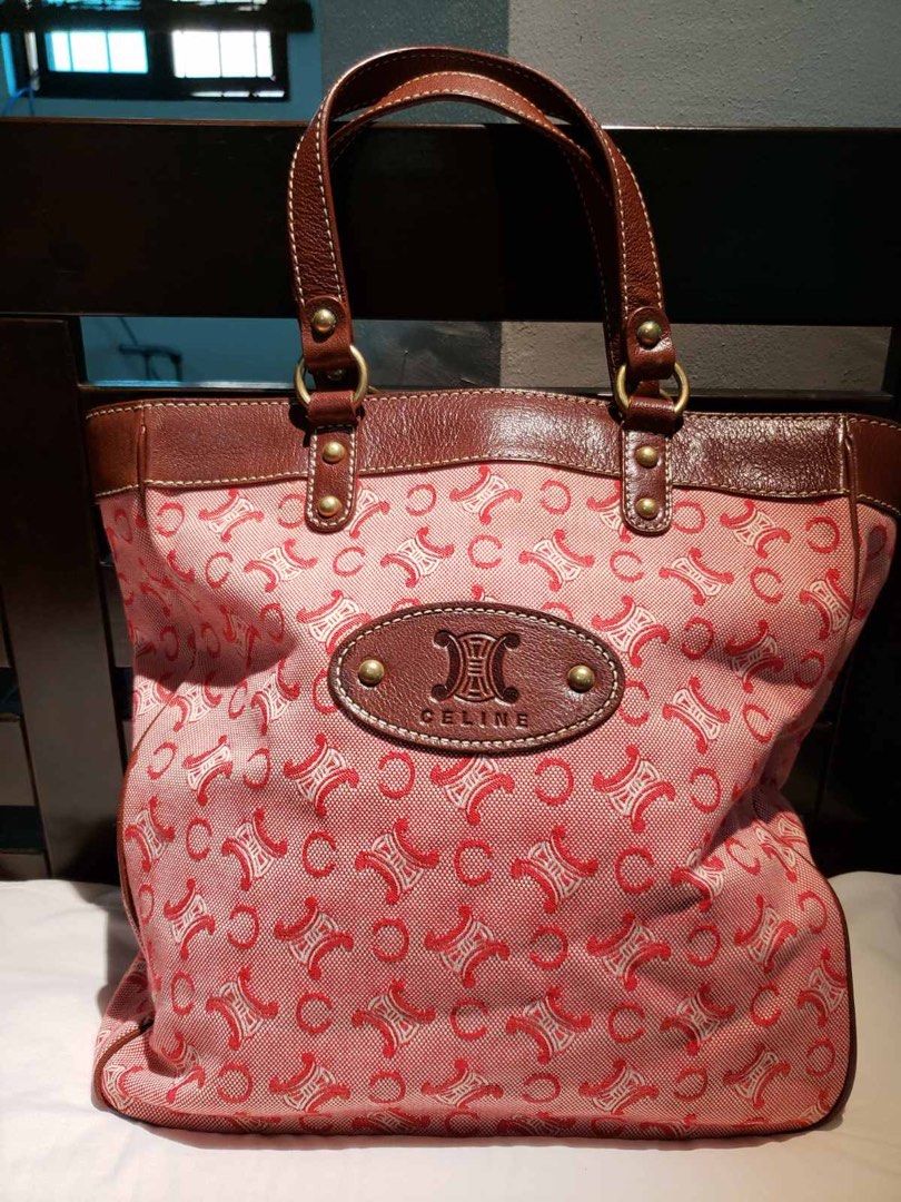 Celine Tote Bag (Category: Luxury Bags & Wallets) located in Cainta. Submitted by lilicute06 (Listing ID 1429938823, Image 1). Description: Celine tote bag with a pink and red pattern. Features brown leather handles and trim. The interior has a beige lining with a zippered pocket. Includes a leather tag inside with the brand name and details. The bag has a zipper closure with a Celine branded pull..