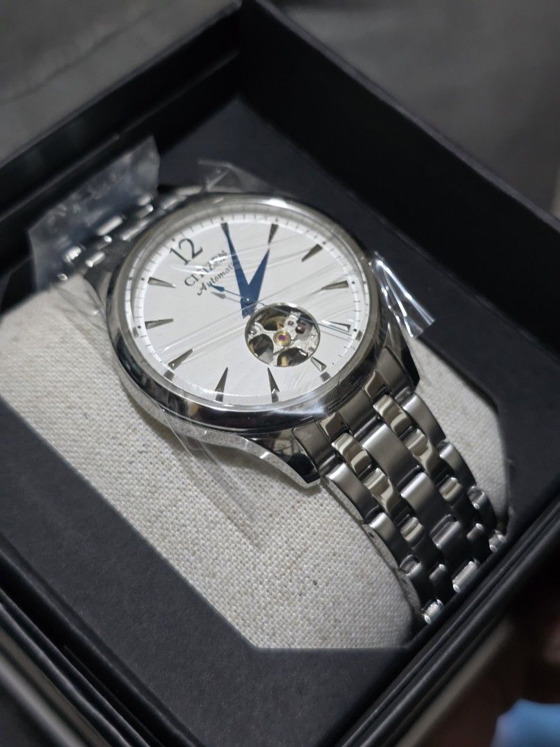 CITIZEN NH9131-73A Open Hearts (Category: Men's Watches) located in Pasig City. Submitted by sai1032013 (Listing ID 1425744354, Image 1). Description: Citizen automatic watch with a silver stainless steel band and a white dial. Features blue hands and a visible movement. The watch has a clasp closure and a transparent case back. The watch is marked "Citizen Watch Co." and "Japan Movt Cased..