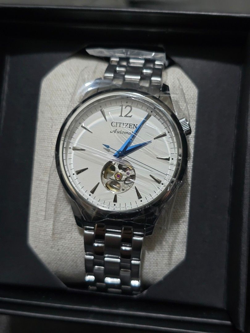CITIZEN NH9131-73A Open Hearts (Category: Men's Watches) located in Pasig City. Submitted by sai1032013 (Listing ID 1425744354, Image 3). Description: Citizen automatic watch with a silver stainless steel band and a white dial. Features blue hands and a visible movement. The watch has a clasp closure and a transparent case back. The watch is marked "Citizen Watch Co." and "Japan Movt Cased..