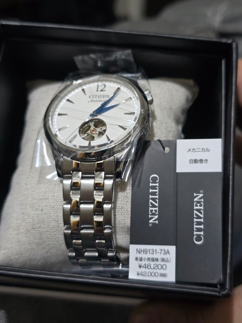 CITIZEN NH9131-73A Open Hearts (Category: Men's Watches) located in Pasig City. Submitted by sai1032013 (Listing ID 1425744354, Image 2). Description: Citizen automatic watch with a silver stainless steel band and a white dial. Features blue hands and a visible movement. The watch has a clasp closure and a transparent case back. The watch is marked "Citizen Watch Co." and "Japan Movt Cased..