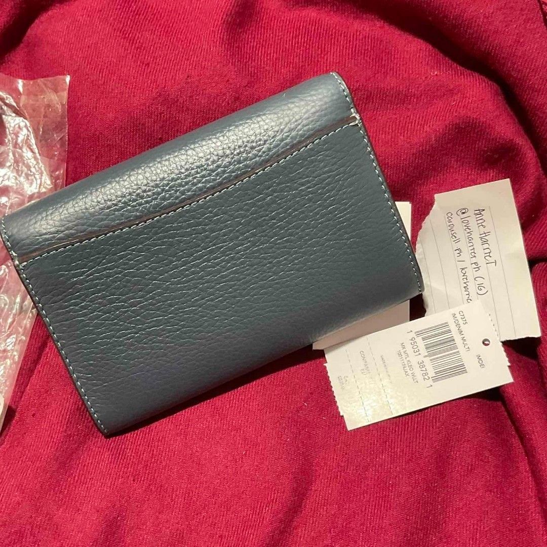 Coach Kleo Wallet (Category: Luxury Bags & Wallets) located in Cavite. Submitted by loveharrietph (Listing ID 1430006049, Image 3). Description: Coach wallet features a stylish buckle closure and a compact design. The wallet is a beautiful blue color and includes the original tags. It's a perfect accessory for everyday use. Style No. C7374 Signature coated canvas and smooth leather credit card slots Inside open pockets Inside zip coin pocket Snap