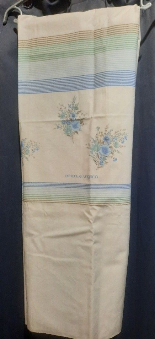 Emanuel Ungaro Floral Bed Sheet (Category: Bedding & Towels) located in Manila. Submitted by cleofetoribio (Listing ID 1429963188, Image 2). Description: Emanuel Ungaro bed sheet featuring a floral design with blue flowers and a striped border. The sheet has the brand name printed on it. 50"×90".