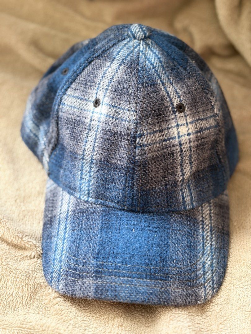 GAP x Pendleton Woolen Mills Cap (Category: Caps & Hats) located in Pili. Submitted by readysetthrift (Listing ID 1429899351, Image 1). Description: Cap features a blue plaid pattern. It is a collaboration between GAP and Pendleton Woolen Mills. The interior is lined with a grey fabric. The cap has a curved brim and an adjustable strap at the back. The tag indicates it is made with wool..