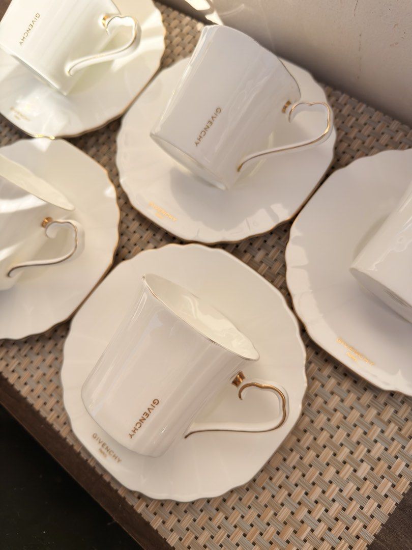 Givenchy Bone China Tea Cup and Saucer DUO (Category: Coffee & Tea Tableware) located in Bulacan. Submitted by fancy.surplusera (Listing ID 1429884869, Image 2). Description: Japan Elegant Givenchy tea cup and saucer set. Features a white bone china design with gold accents. Includes six cups and saucers. Made in Japan. Condition: 7/10 Size: Cup - 7cm x 7cm Saucer - 14.7cm Price sold per piece..