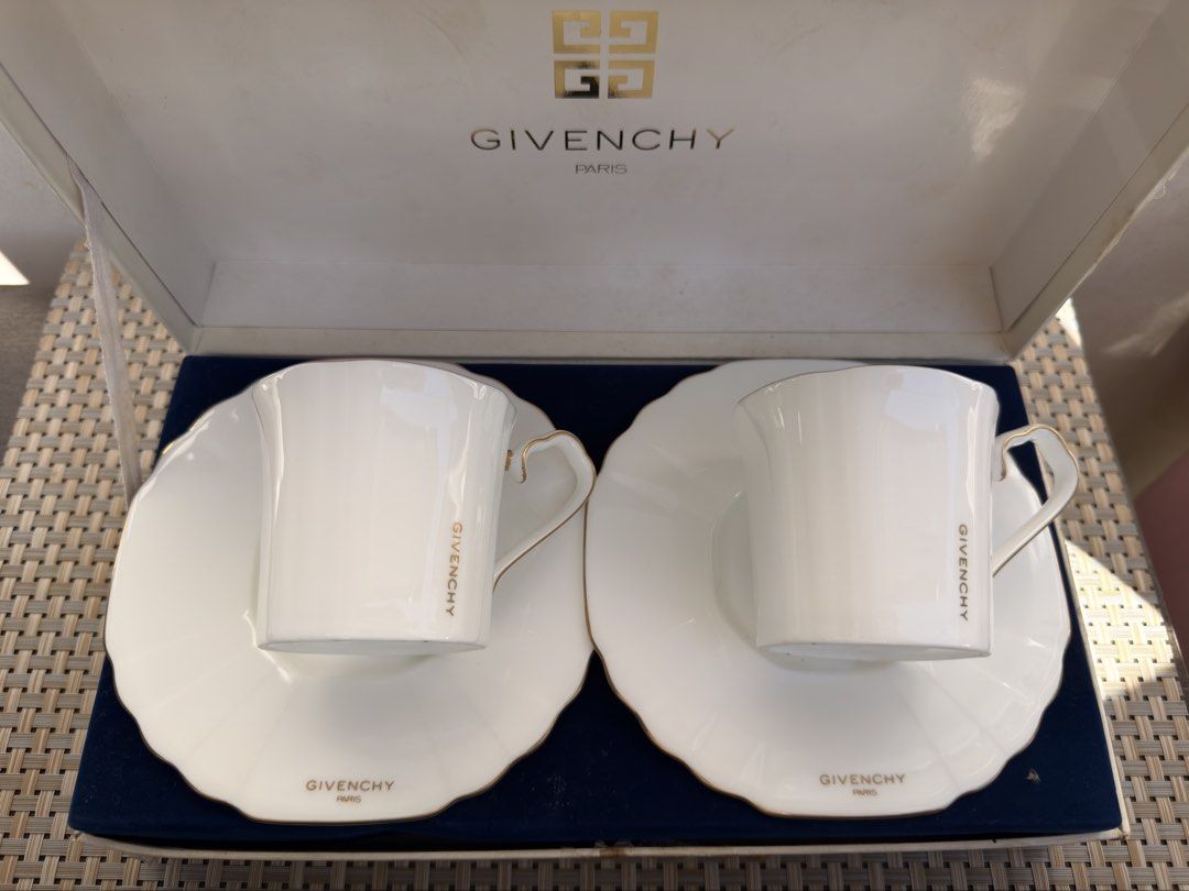 Givenchy Paris Tea Cup and Saucer Set (Category: Coffee & Tea Tableware) located in Bulacan. Submitted by fancy.surplusera (Listing ID 1429898782, Image 2). Description: Elegant Givenchy Paris tea cup and saucer set. Features a white porcelain design with gold trim and the Givenchy logo. Includes two cups and two saucers, presented in their original box. Made in Japan. A sophisticated addition to any tea collection. Condition: 10/10 Size: Cup - 7