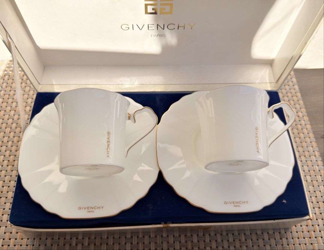 Givenchy Paris Tea Cup and Saucer Set (Category: Coffee & Tea Tableware) located in Bulacan. Submitted by fancy.surplusera (Listing ID 1429898782, Image 1). Description: Elegant Givenchy Paris tea cup and saucer set. Features a white porcelain design with gold trim and the Givenchy logo. Includes two cups and two saucers, presented in their original box. Made in Japan. A sophisticated addition to any tea collection. Condition: 10/10 Size: Cup - 7