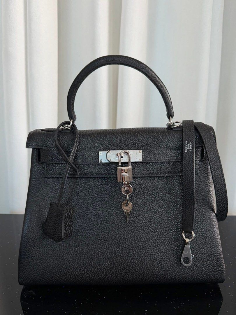 Kelly 28 Tophandle (Category: Luxury Bags & Wallets) located in Manila. Submitted by bagsandshoesmanymore (Listing ID 1429849595, Image 3). Description: Preloved Kelly bag. Size 28cm Silver hardware Genuine leather Features a top handle, shoulder strap, and a lock with keys. The bag is black with silver hardware. Includes a dust bag. Made in France..