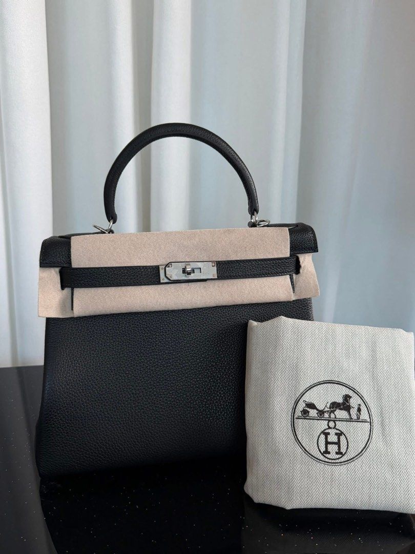 Kelly 28 Tophandle (Category: Luxury Bags & Wallets) located in Manila. Submitted by bagsandshoesmanymore (Listing ID 1429849595, Image 1). Description: Preloved Kelly bag. Size 28cm Silver hardware Genuine leather Features a top handle, shoulder strap, and a lock with keys. The bag is black with silver hardware. Includes a dust bag. Made in France..