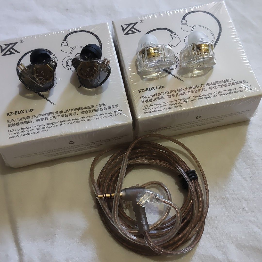 KZ-EDX Lite In-Ear Earphones (Category: Earphones) located in Paranaque City. Submitted by audioaddict0517 (Listing ID 1429868089, Image 1). Description: KZ-EDX Lite in-ear earphones. The earphones come with a detachable cable and are packaged in a box. The box features the KZ logo and the model name. The earphones themselves have a transparent design, allowing a view of the internal components. The cable has a gold-plated connector..