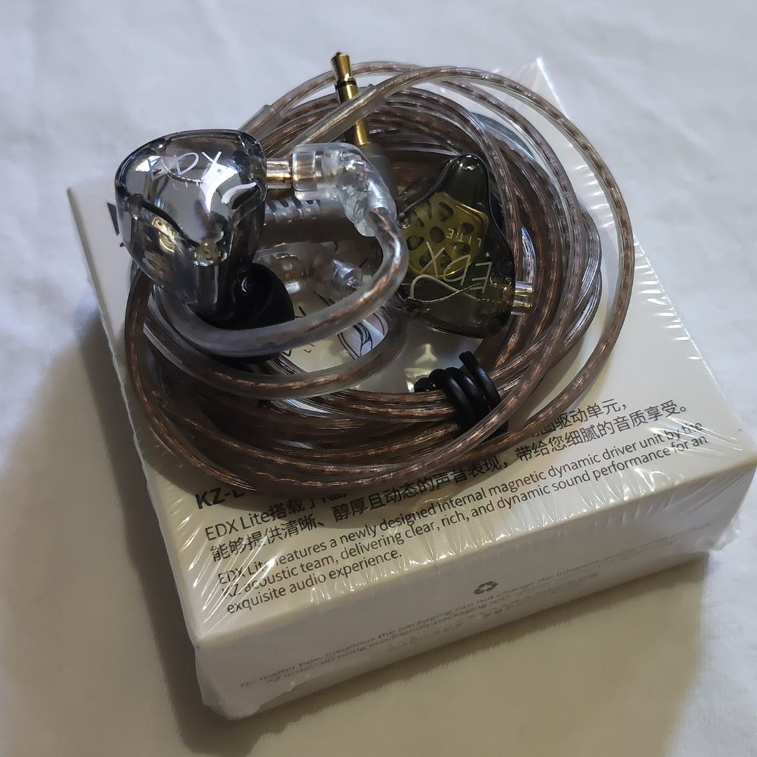 KZ-EDX Lite In-Ear Earphones (Category: Earphones) located in Paranaque City. Submitted by audioaddict0517 (Listing ID 1429868089, Image 3). Description: KZ-EDX Lite in-ear earphones. The earphones come with a detachable cable and are packaged in a box. The box features the KZ logo and the model name. The earphones themselves have a transparent design, allowing a view of the internal components. The cable has a gold-plated connector..