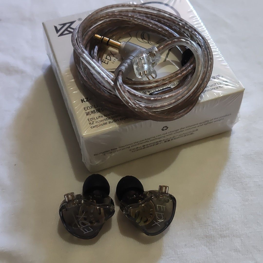 KZ-EDX Lite In-Ear Earphones (Category: Earphones) located in Paranaque City. Submitted by audioaddict0517 (Listing ID 1429868089, Image 2). Description: KZ-EDX Lite in-ear earphones. The earphones come with a detachable cable and are packaged in a box. The box features the KZ logo and the model name. The earphones themselves have a transparent design, allowing a view of the internal components. The cable has a gold-plated connector..