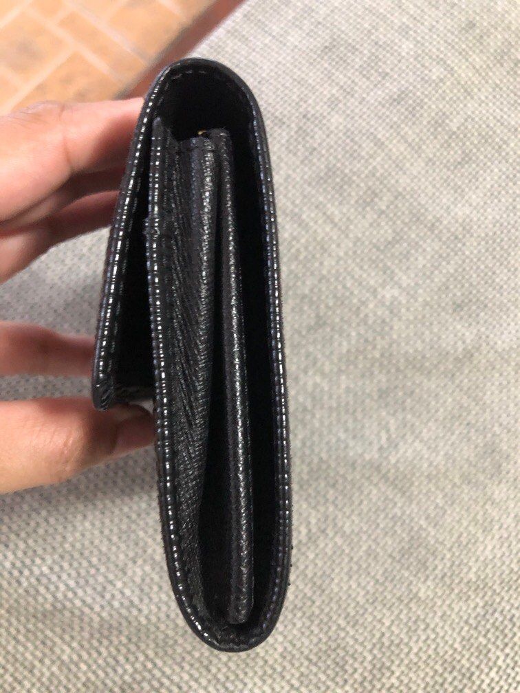 Louis Vuitton Epi Leather Wallet (Category: Luxury Bags & Wallets) located in Cainta. Submitted by lilicute06 (Listing ID 1429936088, Image 2). Description: Black Louis Vuitton Epi Leather wallet. Features a textured exterior and a snap closure. The interior includes multiple compartments and a zippered pocket. The design is sleek and classic, perfect for everyday use..
