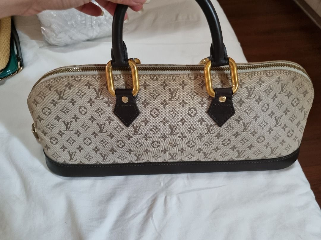 Louis Vuitton Mini Lin Alma Handbag (Category: Luxury Bags & Wallets) located in Makati City. Submitted by maria.cab1980 (Listing ID 1429926699, Image 1). Description: Authentic Louis Vuitton Mini Lin Alma handbag. Features a beige and brown monogram canvas exterior with dark brown leather trim and handles. Includes a gold-tone zipper closure and padlock. The interior is lined with a light beige fabric. The base has protective feet. Made in Franc