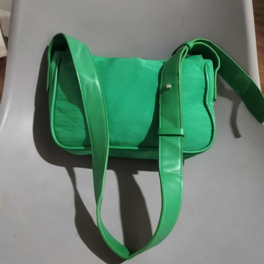 Matin Kim Green Shoulder Bag (Category: Luxury Bags & Wallets) located in Sindangan. Submitted by mix_thrift0308 (Listing ID 1429991909, Image 3). Description: Vibrant green shoulder bag features a unique buckle closure. The bag has a long, adjustable strap and a spacious interior. The brand name "Matin Kim" is visible on the buckle. The bag has a sleek, modern design, perfect for everyday use..