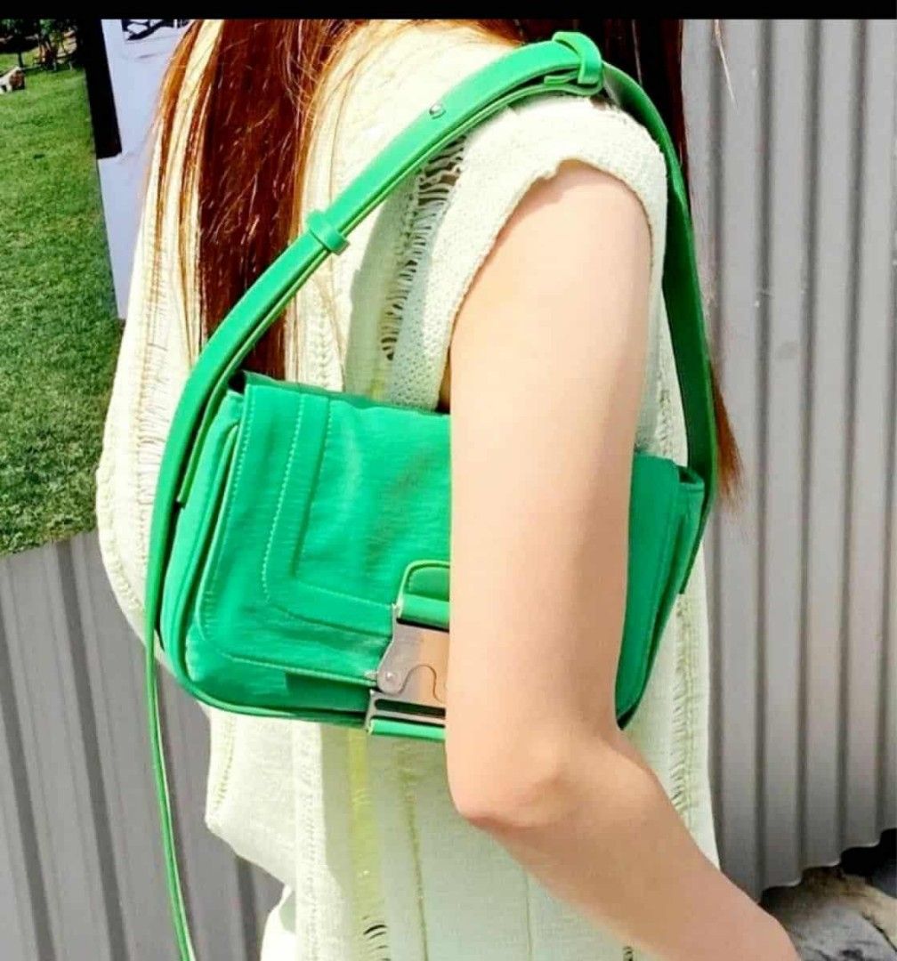 Matin Kim Green Shoulder Bag (Category: Luxury Bags & Wallets) located in Sindangan. Submitted by mix_thrift0308 (Listing ID 1429991909, Image 1). Description: Vibrant green shoulder bag features a unique buckle closure. The bag has a long, adjustable strap and a spacious interior. The brand name "Matin Kim" is visible on the buckle. The bag has a sleek, modern design, perfect for everyday use..