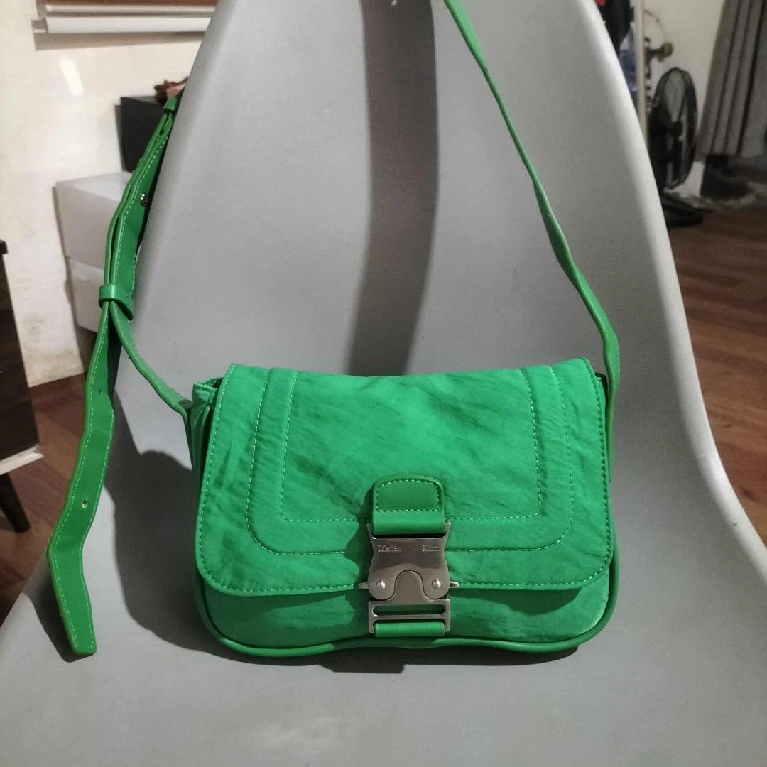 Matin Kim Green Shoulder Bag (Category: Luxury Bags & Wallets) located in Sindangan. Submitted by mix_thrift0308 (Listing ID 1429991909, Image 2). Description: Vibrant green shoulder bag features a unique buckle closure. The bag has a long, adjustable strap and a spacious interior. The brand name "Matin Kim" is visible on the buckle. The bag has a sleek, modern design, perfect for everyday use..