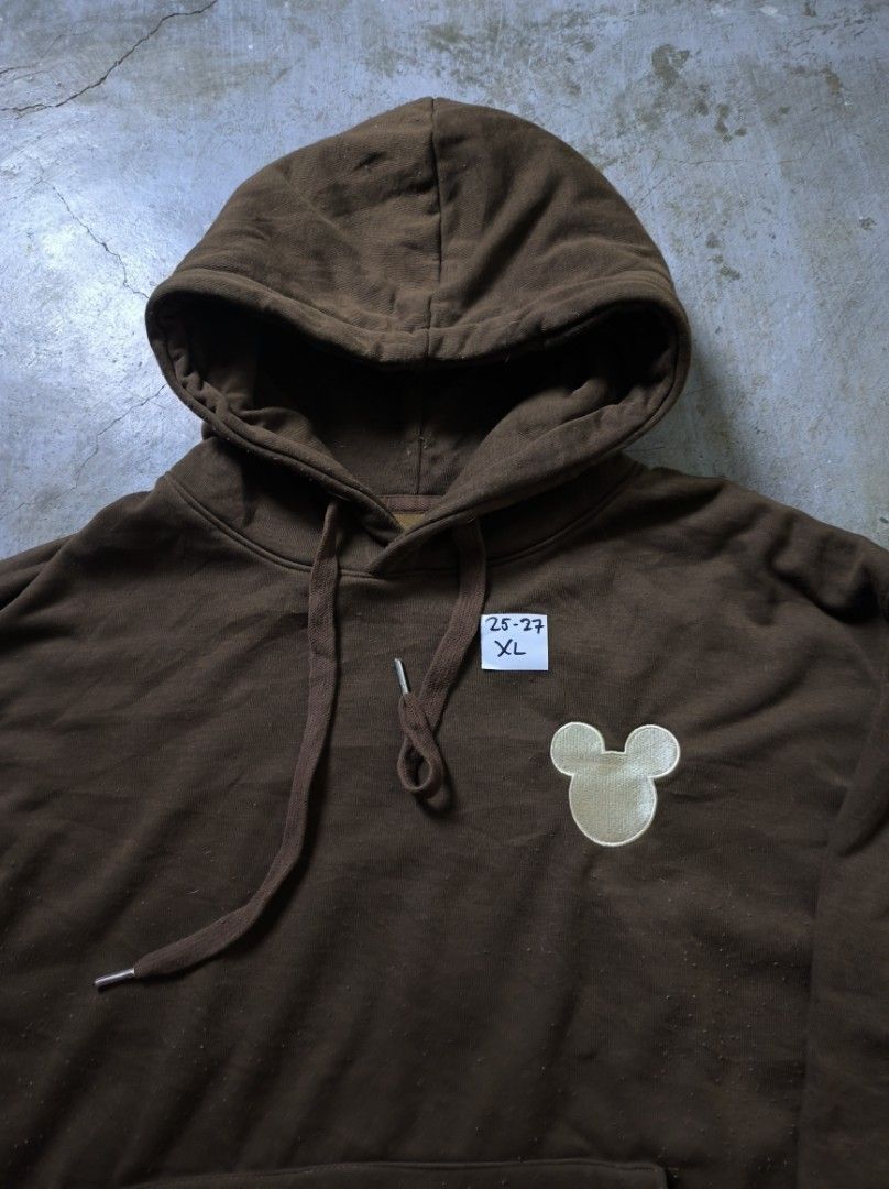 Mickey Mouse Brown Hoodie XL (Category: Hoodies) located in Manila. Submitted by suppliermo (Listing ID 1429909066, Image 3). Description: Brown hoodie with a Mickey Mouse design on the chest. Features a hood with drawstrings and a front pocket. The size tag indicates XL. The hoodie has ribbed cuffs and hem. The color is a solid brown..