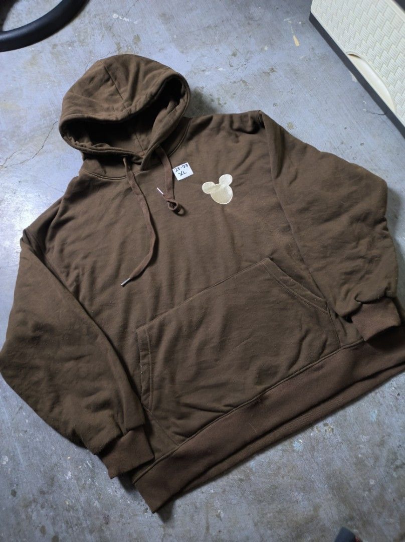Mickey Mouse Brown Hoodie XL (Category: Hoodies) located in Manila. Submitted by suppliermo (Listing ID 1429909066, Image 2). Description: Brown hoodie with a Mickey Mouse design on the chest. Features a hood with drawstrings and a front pocket. The size tag indicates XL. The hoodie has ribbed cuffs and hem. The color is a solid brown..