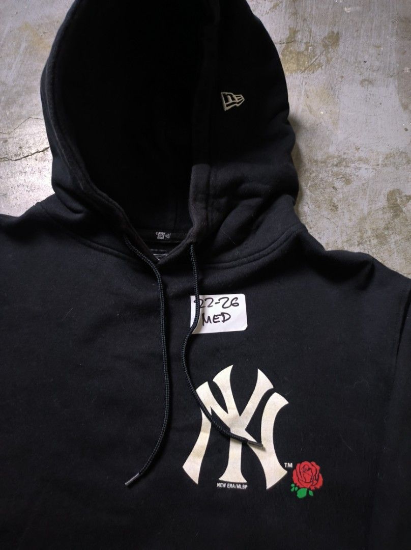 New Era Yankees Hoodie (Category: Hoodies) located in Manila. Submitted by suppliermo (Listing ID 1429909076, Image 2). Description: Black hoodie featuring the New York Yankees logo with a rose graphic. It has a front pocket and a hood. The New Era logo is visible on the hood. The size is Medium..